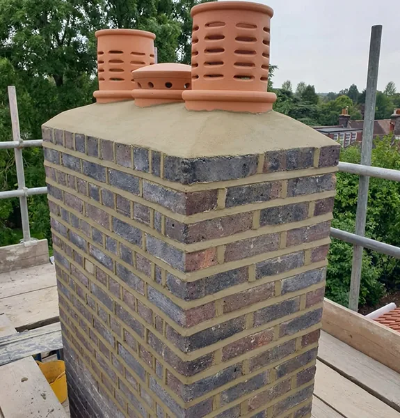 Repaired chimney stack with new flaunching, repointing and terracotta pots